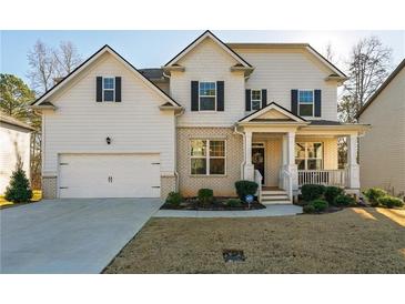 Two-story house with white siding, brick accents, and a front porch at 5964 Wolf Creek Dr, Atlanta, GA 30349