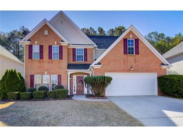 Charming two-story brick home with manicured landscaping and a two-car garage at 3258 Kessock Ridge Trl, Snellville, GA 30039