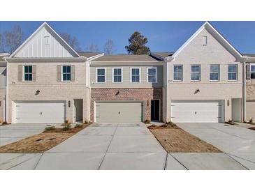 Three-unit townhome building with neutral brick and siding at 4521 Twinberry Dr, Powder Springs, GA 30127