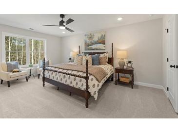 This bedroom features carpet floors, a four-poster bed, natural light, and neutral paint at 4521 Twinberry Dr, Powder Springs, GA 30127