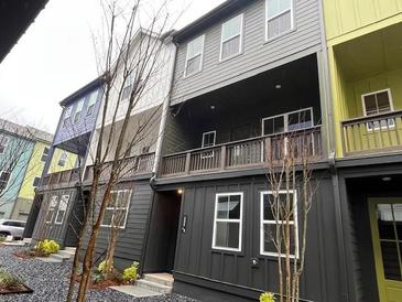 View of colorful townhomes with covered balconies and sidewalk access, located in a vibrant neighborhood at 508 Zeal Se St # 292, Atlanta, GA 30315