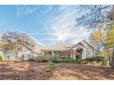 Gray two-story house with a wrap-around porch and stone accents at 2727 Jamerson Rd, Marietta, GA 30066