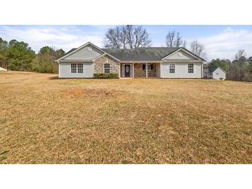 Charming ranch-style home with stone accents and a well-maintained yard at 85 Blue Jay Dr, Covington, GA 30016