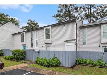 Charming townhome with a fenced yard and a manicured lawn at 257 Country Club Dr, Jonesboro, GA 30238