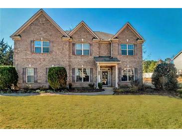 Charming brick two-story home with a well-maintained lawn and mature landscaping at 200 Claret Way, Mcdonough, GA 30252