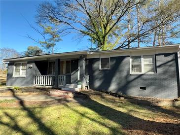 Gray brick ranch house with a landscaped yard at 6828 Delta Dr, Riverdale, GA 30274