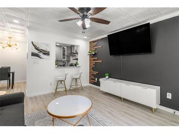 Modern living room features an open floor plan, stylish decor, and a pass-through view to the kitchen at 1225 Church St # O, Decatur, GA 30030