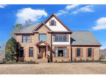 Charming two-story brick home with a gabled roof, shutters, and a well-manicured lawn at 416 Telfair Way, Canton, GA 30115