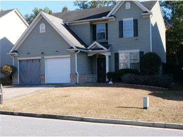 Two-story house with gray siding, two-car garage, and landscaping at 6053 Hemperly Rd, Atlanta, GA 30349