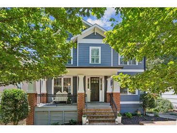 Two-story craftsman home with blue siding, brick accents, and a charming front porch at 875 Berne Se St, Atlanta, GA 30316