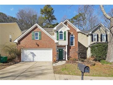 Charming two-story brick home with attached garage and well-manicured landscaping at 485 Kensington Parc Dr, Avondale Estates, GA 30002