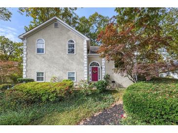 Attractive two-story house with a red door and landscaping at 1045 Sterling Ridge Chase, Marietta, GA 30062