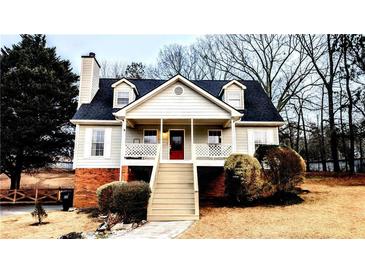 Charming raised ranch home with a red door and wrap-around porch at 4045 Mark Todd Ct, Hoschton, GA 30548