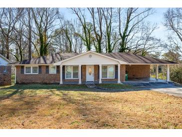 Brick ranch house with covered porch and large yard at 1801 Se Caribaea Se Trl, Atlanta, GA 30316