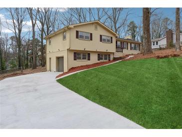 Ranch home with attached garage and landscaped yard at 1573 Deerwood Ln, Acworth, GA 30102