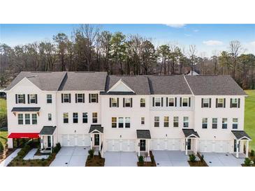 Modern townhome exteriors feature white brick, black shutters, and individual garages at 250 Lytham Se Dr, Mableton, GA 30126