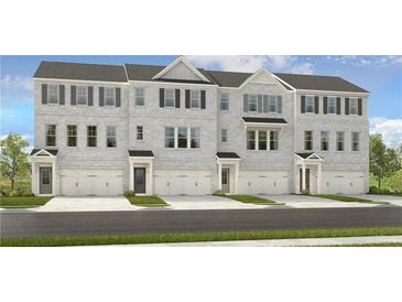 Three-story townhouses with gray brick exterior, two-car garages, and landscaping at 242 Lytham Se Dr, Mableton, GA 30126