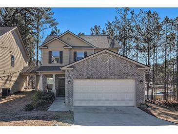 Two-story house with brick and siding, attached garage, and landscaping at 6292 Hickory Lane Cir, Union City, GA 30291