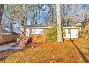 Brick ranch home with a landscaped yard and steps leading to the front entrance at 2259 Nelms Sw Dr, Atlanta, GA 30315