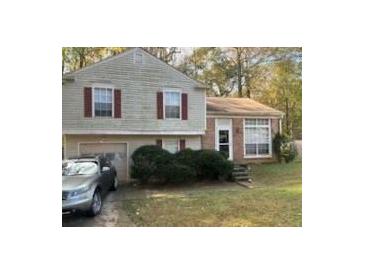 Two-story house with attached garage and landscaping at 1975 Longwood Ct, Lithonia, GA 30058