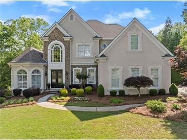 Stunning two-story home boasts a manicured lawn and beautiful landscaping at 2960 Millwater Xing, Dacula, GA 30019