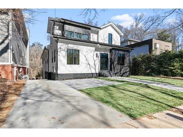 Stunning two-story modern farmhouse with black and white exterior, landscaped lawn, and driveway at 904 Kings Cct Ne Ne, Atlanta, GA 30306