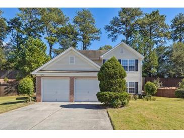 Two-story house with a two-car garage and well-maintained lawn at 1331 Pine Acre Dr, Sugar Hill, GA 30518