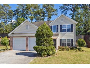 Two-story house with a two-car garage and well-manicured lawn at 1331 Pine Acre Dr, Sugar Hill, GA 30518