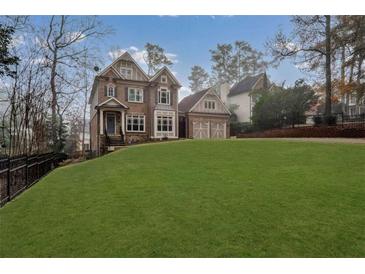 Two-story house with brick facade, large windows, and a spacious lawn at 2733 Caldwell Rd, Brookhaven, GA 30319