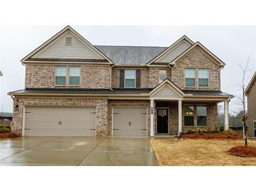 Beautiful two-story brick home with attached two-car garage and covered front porch at 3004 Amabile Rd, Dacula, GA 30019