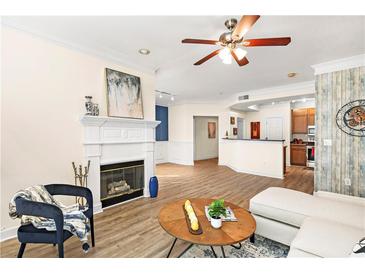 Inviting living room boasts fireplace, ceiling fan, and open access to the kitchen and dining area at 234 Ashford Cir, Atlanta, GA 30338