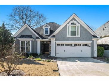 Gray two-story house with white garage door and landscaping at 107 Wexford Ct, Stockbridge, GA 30281