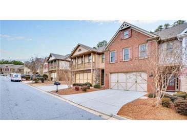 Brick townhome with 2-car garage, located in a quiet community at 5760 Vista Brook Dr, Suwanee, GA 30024