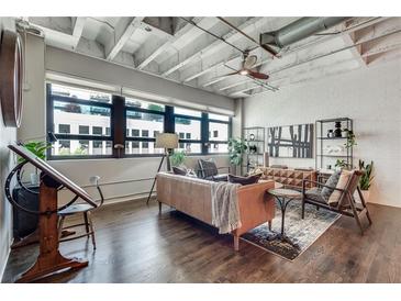 Bright and spacious living room with large windows and modern furnishings in an industrial condo at 878 Peachtree Ne St # 535, Atlanta, GA 30309