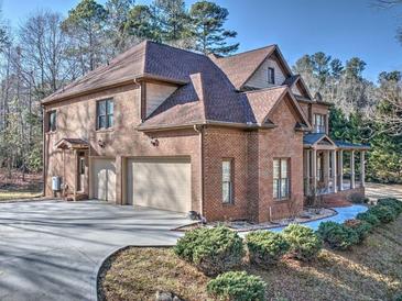 Brick home with three-car garage and landscaped grounds at 1411 River Station Dr, Lawrenceville, GA 30045