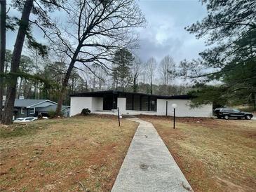 Charming single-story home features a modern design, manicured lawn, and inviting walkway at 5145 Dublin Sw Dr, Atlanta, GA 30331