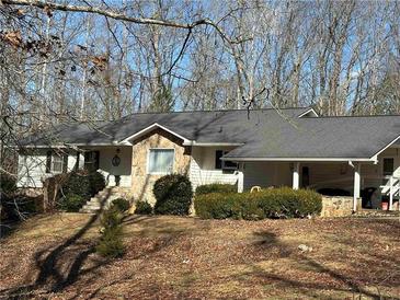 Ranch home featuring stone accents, mature trees, and a large front yard at 4286 Pool Rd, Winston, GA 30187