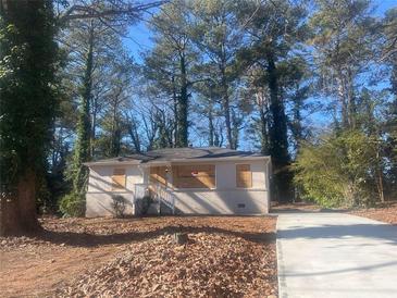 Newly renovated house with a gray exterior and a paved driveway at 1901 Oak Valley Rd, Decatur, GA 30035