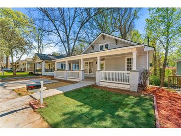 Gray craftsman home with a front porch and newly sodded lawn at 1066 Sw White Oak Ave, Atlanta, GA 30310