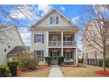 Two-story house with gray siding, front porch, and landscaping at 1968 Perry Nw Blvd, Atlanta, GA 30318