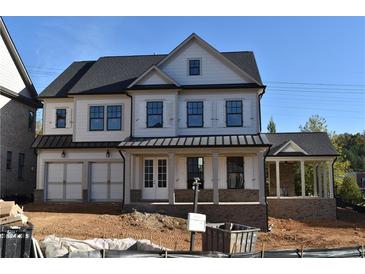 Two-story home features a front porch, gray roof, and white siding at 3065 Barnes Mill Ct, Roswell, GA 30075