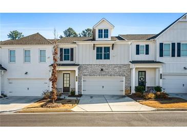 Two story townhome with white and gray siding, stone accents, and two-car garage at 1706 Pardee Dr, Kennesaw, GA 30152