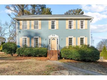 Two-story house with blue siding, beige shutters, and a manicured lawn at 718 Creek Nw Trl, Kennesaw, GA 30144