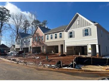 Three-unit townhome development showcasing modern design and attached garages at 405 Carrera Ln, Acworth, GA 30102