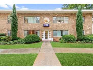 Charming apartment building with a brick facade, manicured lawn, and inviting entrance with the building number 200 at 2240 Cheshire Bridge Rd # 205, Atlanta, GA 30324