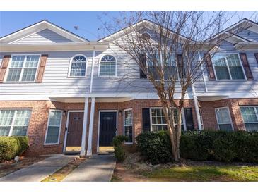 Charming two-story townhome with brick facade and well-maintained landscaping at 2566 Walden Lake Dr, Decatur, GA 30035