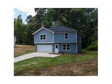 Newly built 2-story house with a gray driveway and attached garage at 1351 E Atlanta E Rd, Stockbridge, GA 30281