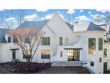 Stunning white two-story home with gray roof and large windows at 1890 W Paces Ferry Nw Rd, Atlanta, GA 30327