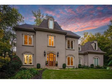 Elegant two-story home with manicured lawn and charming facade at 302 Rolling Rock Se Rd, Marietta, GA 30067