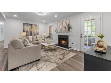 Spacious living room with fireplace and hardwood floors at 9404 Cypress Ln, Jonesboro, GA 30238